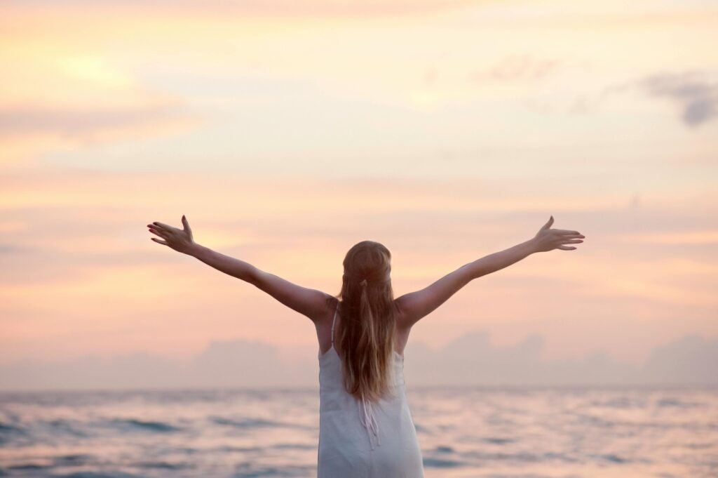pexels-photo-320007-320007 Rear View of Woman With Arms Raised at Beach during Sunset